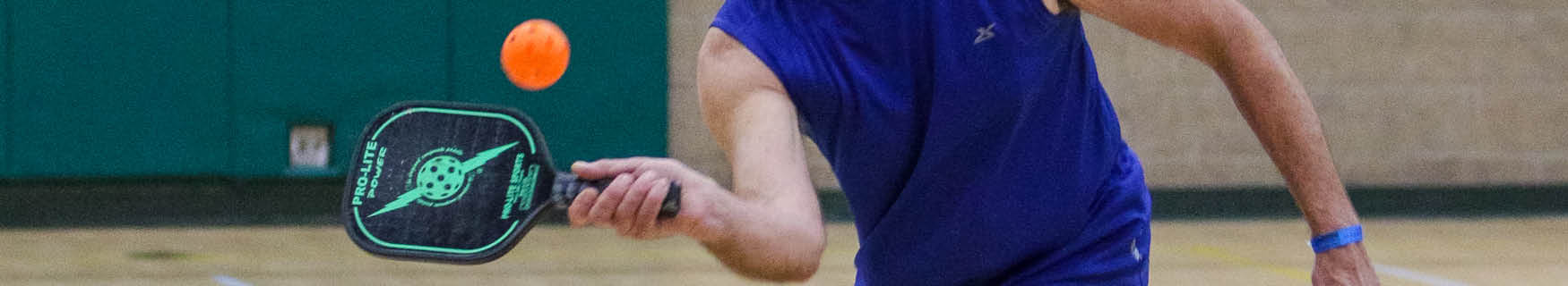 close up of pickleball paddle and ball