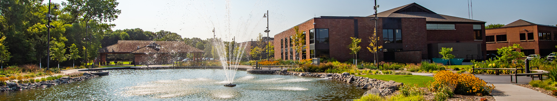 view of the pond, pavilion, and community center